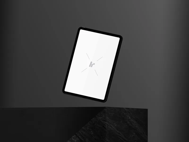 iPad Pro floating on a rock cube against a neutral background.