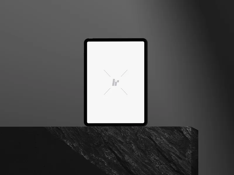 iPad Pro on a cube-shaped rock, viewed straight on.