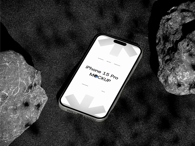 iPhone Pro on rock, top view, against sandy background