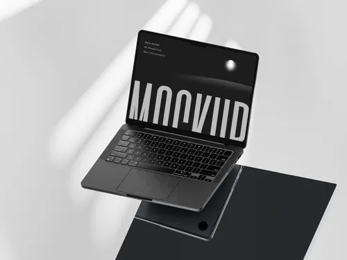 MacBook Pro on dark glass with floating title overlay