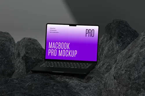 MacBook Pro on dark rock surface, front view