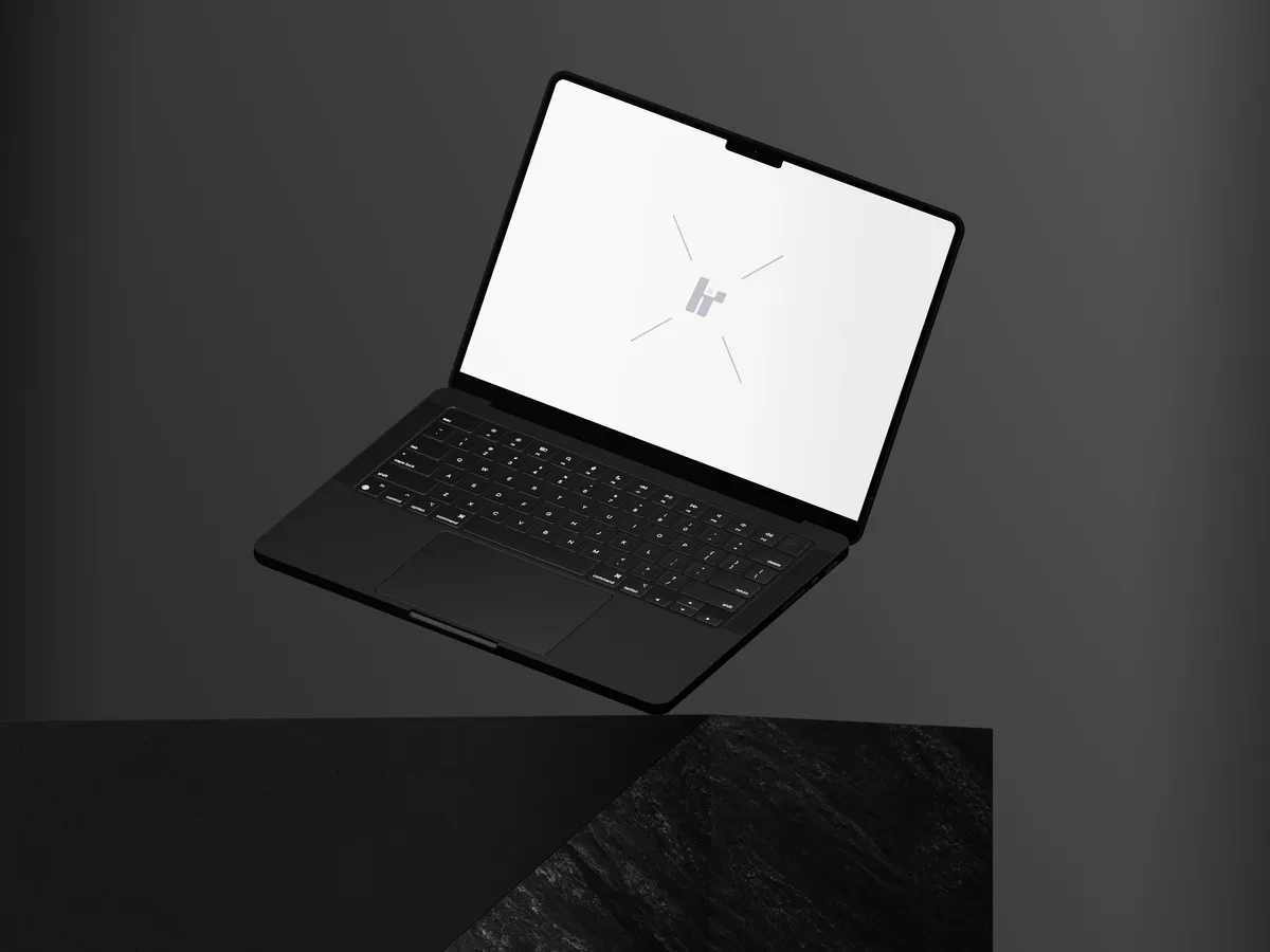 MacBook Pro on a rock, floating at an angle.