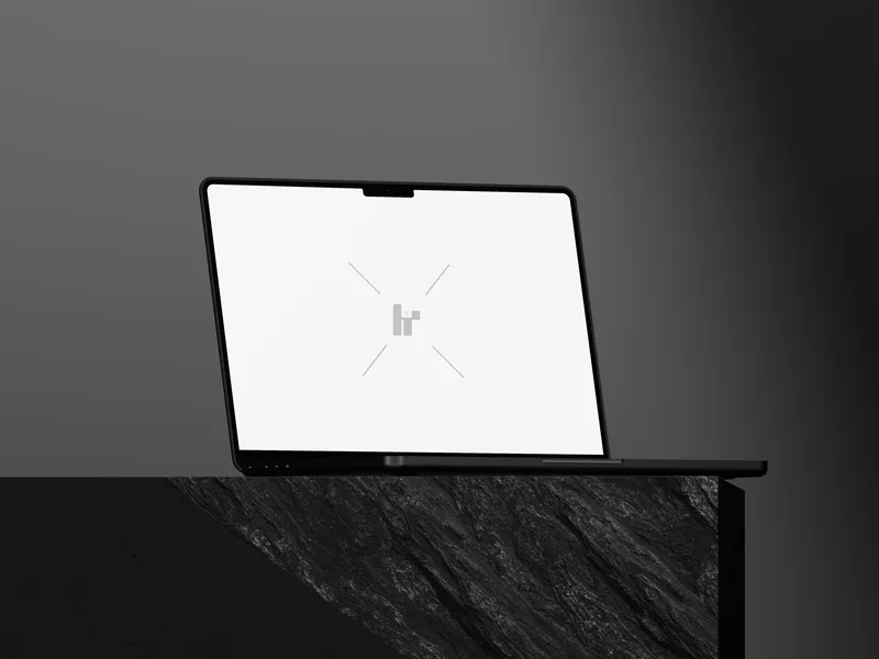 MacBook Pro on a rock cube, viewed from the left.