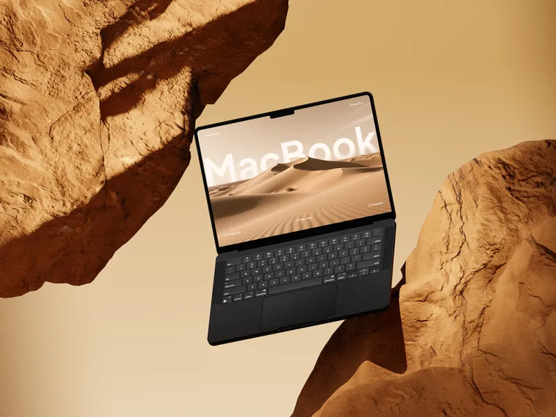 Yellow MacBook Pro floating in front of a rock formation