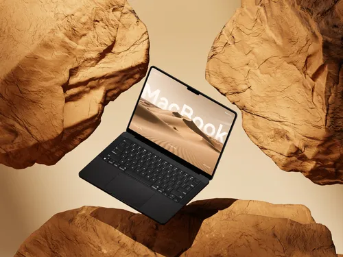 MacBook Pro on yellow rock, floating at an angle, viewed from the left