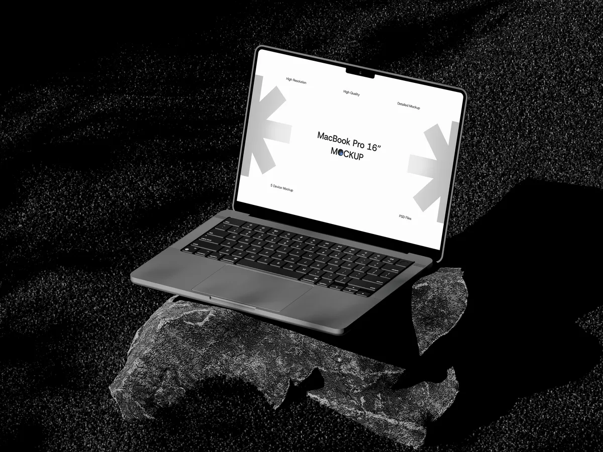 MacBook Pro on rock, top-right view, open screen